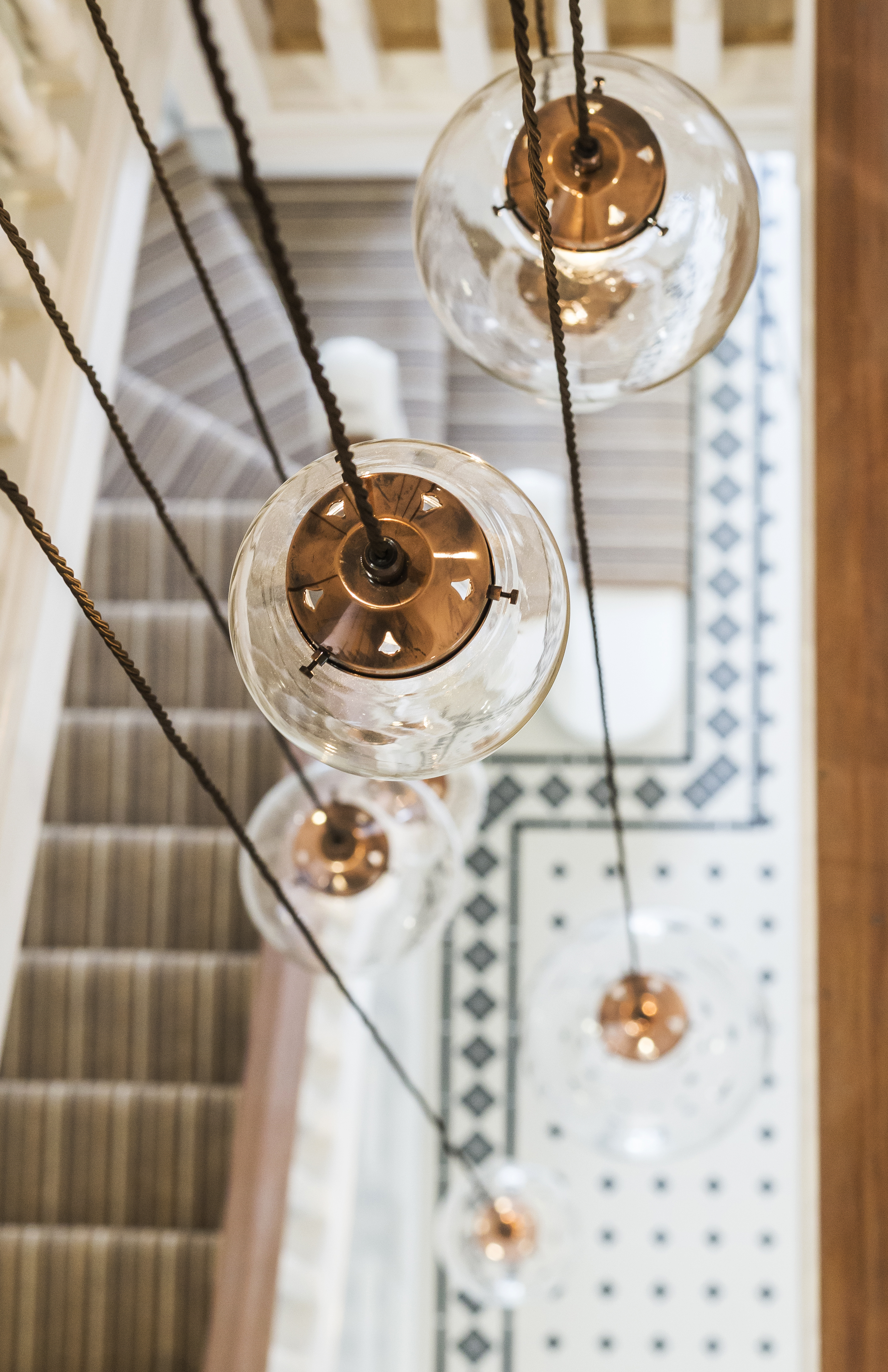 Photo of Rako powered glass lamps hanging above stairwell